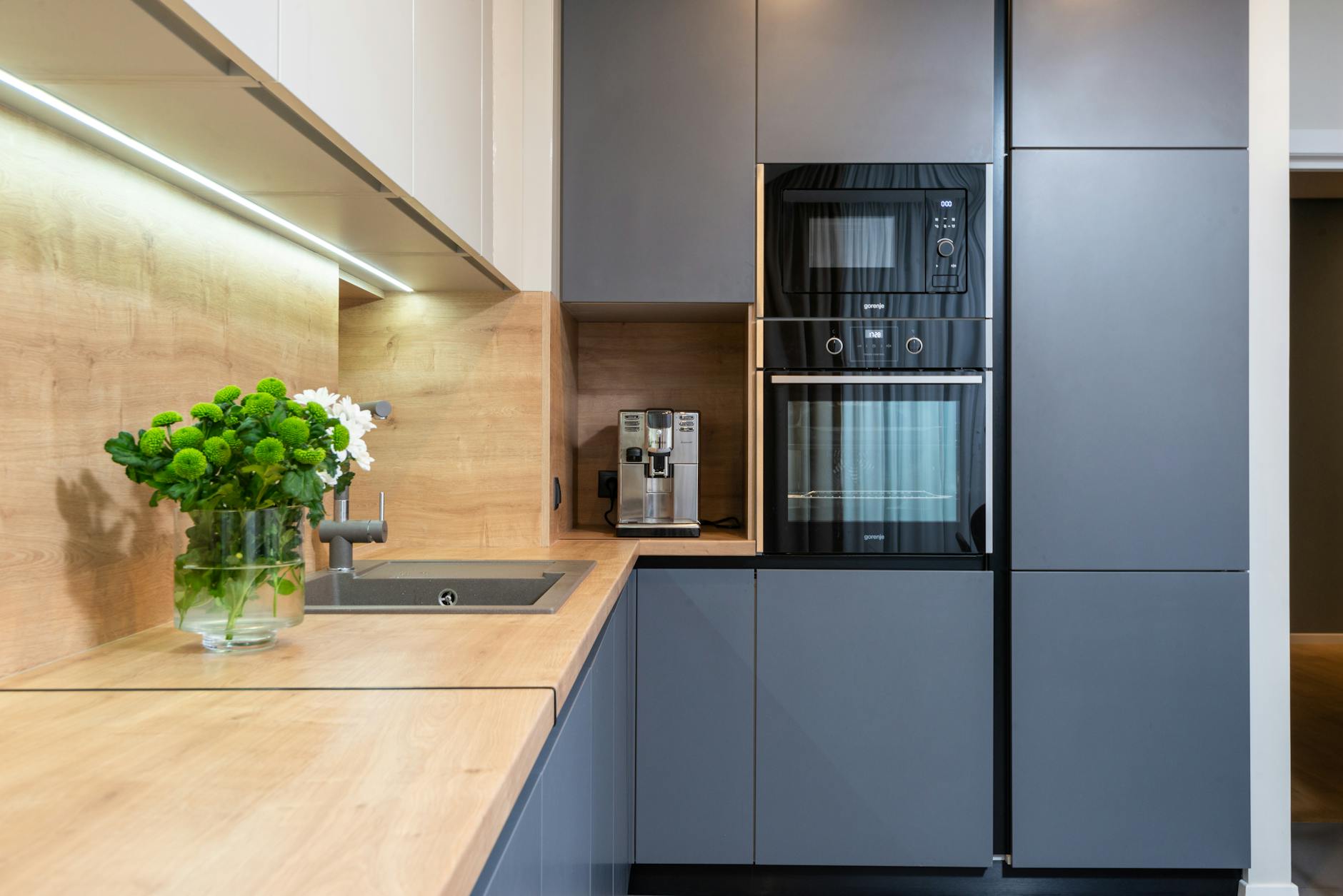 modern kitchen interior with cabinets and electric appliances at home